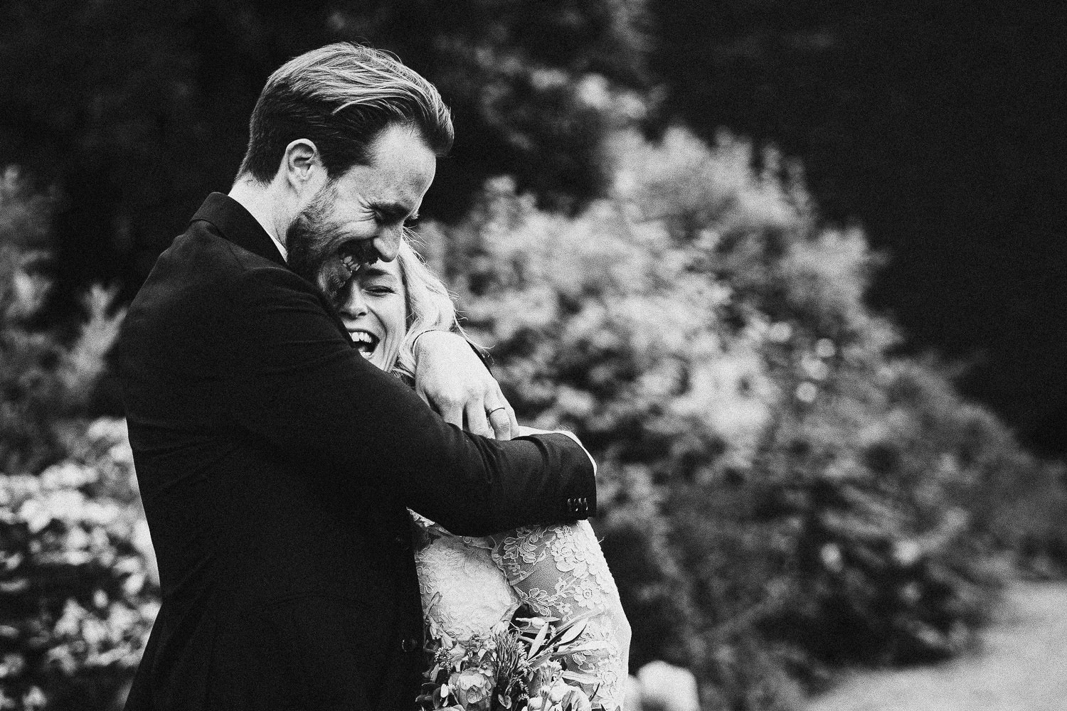 Groom hugs bride